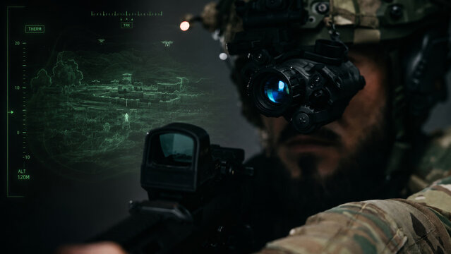 First person night vision battlefield scene with armed soldier, tactical rifle sight, range data, navigation overlay and covert reconnaissance mission