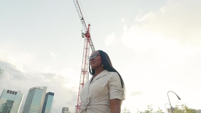 Elegant woman wearing glasses smiling in the city center
