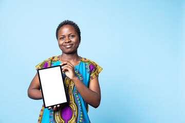 Confident woman showing tablet with blank mockup layout, creating advertisement with isolated copyspace template on wireless device, African American girl presents white display on camera. © DC Studio