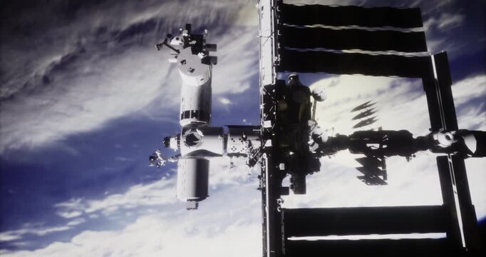 The International Space Station floats above Earth, capturing the intricate details of its structure. The vast blue and white expanse of the planet creates a stunning visual contrast.