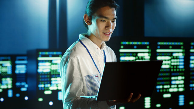 Computer scientist strolling through server rows providing processing resources for different workloads, system administrator monitoring supercomputers tasked with solving complex operations.