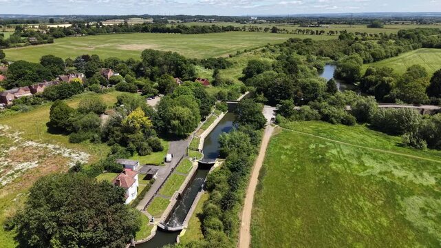 Aerial drone footage of the picturesque village of Culham in Oxfordshire, England, showcasing traditional homes, surrounding farmland, and the peaceful English countryside