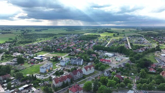 Aerial Drawsko Poland historic rural city 2. Overhead of historic agricultural based town and economy. Neighborhood, homes, apartments and city village business. Old church in market square. European.