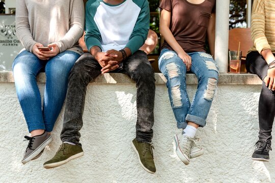 Casual friends sitting together outdoors