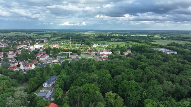 Aerial Drawsko Poland historic rural city 2. Overhead of historic agricultural based town and economy. Neighborhood, homes, apartments and city village business. Old church in market square. European.