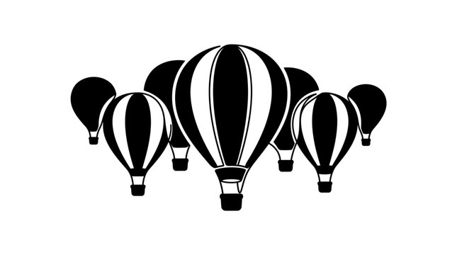 A collection of black and white hot air balloons flying together in the sky.