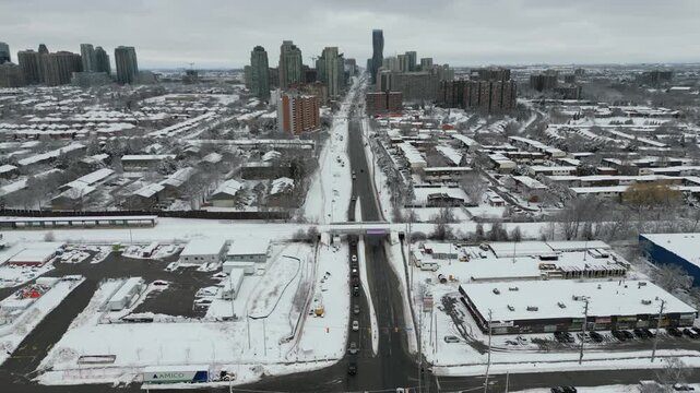 Aerial over Mississauga, Ontario, Canada on a cold winter morning after snowfall, March, 2023. Fairview, Cooksville along Highway 10 Hurontario Street towards the downtown condominium skyline.
