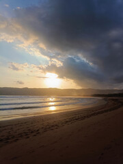 Fototapeta premium Tropical Seaside Sunset with Dramatic Sky and Ocean Reflection