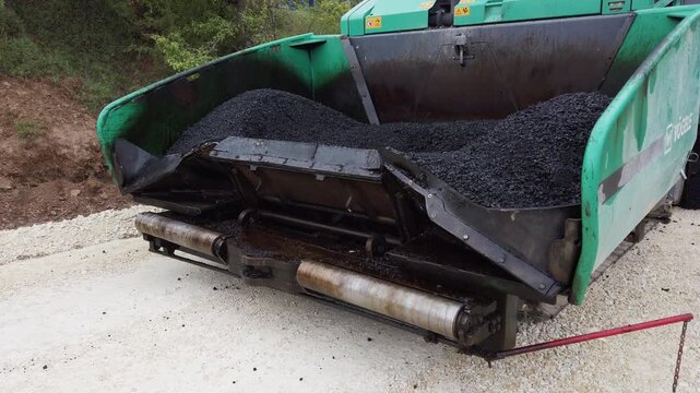 Road construction. Asphalt pavement machine making new layer of asphalt