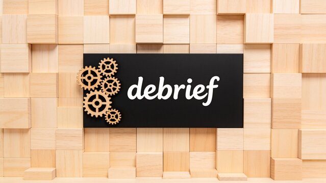 Wooden blocks and gears with debrief text