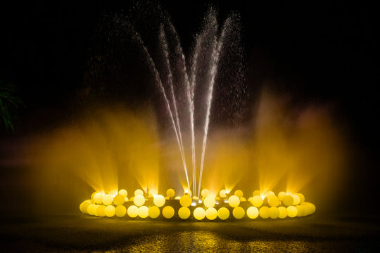 Golden lights at water fountain with atmosphere effect