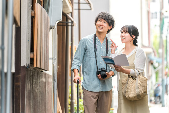 Young couples enjoying walking tours and sightseeing in cities during domestic travel.