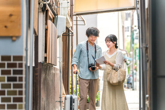 Young couples enjoying walking tours and sightseeing in cities during domestic travel.