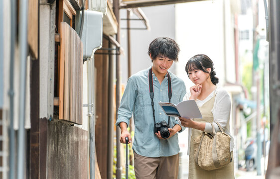 Young couples enjoying walking tours and sightseeing in cities during domestic travel.