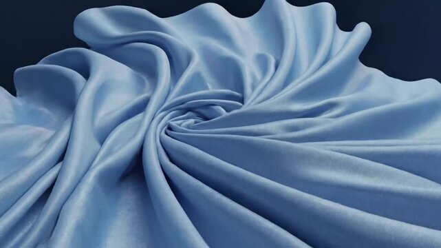 Flowing blue silk fabric floating on dark blue background