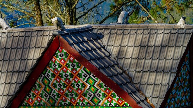 colorful wooden bird on the roof