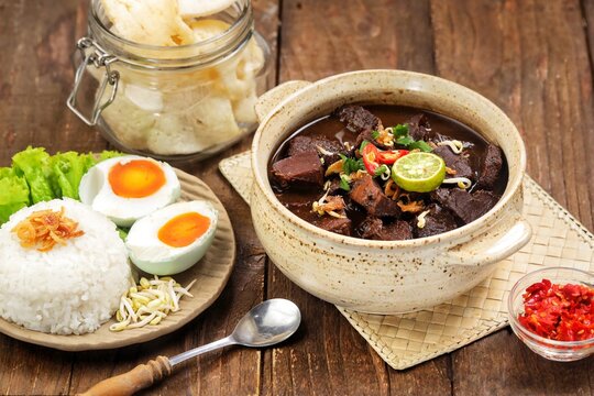 Rawon, a rich black beef soup from East Java made with tender beef and keluak nuts, served with steamed rice, bean sprouts, salted egg, and sambal