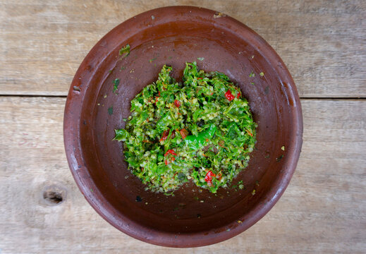 Traditional Green Chili Sambal Served in Brown Mortar Bowl