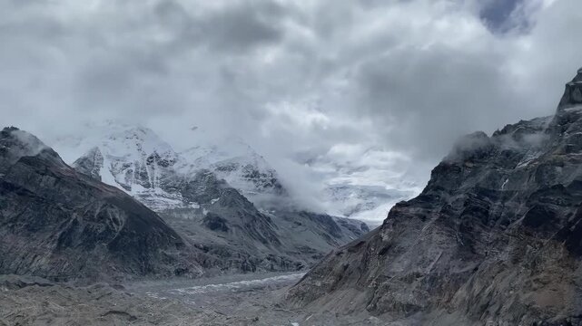 Cloudy panorama of Kanchenjunga Base Camp (North) and the Kanchenjunga Glaciers in the Nepalese Himalayas, showcasing dramatic alpine peaks, rugged moraine, and remote mountain wilderness.