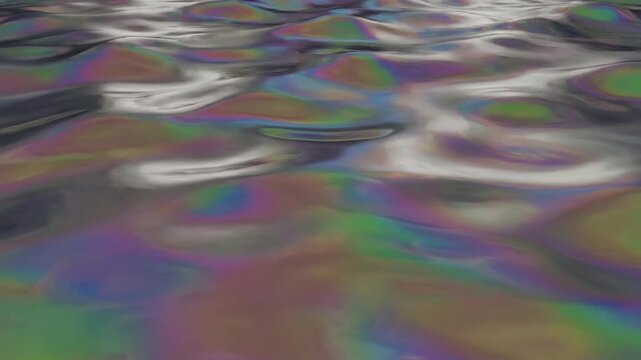 Iridescent oil slick texture on water surface waves.