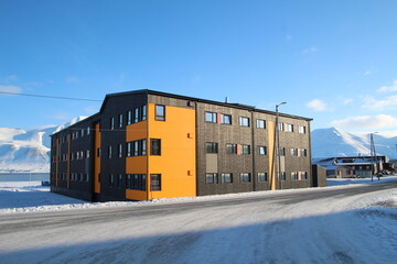 Longyearbyen town panorama in Svalbard, Norway. Remote arctic settlement with colorful houses, traditional wooden architecture, industrial heritage under winter snow and majestic polar mountains. © 國樹潘