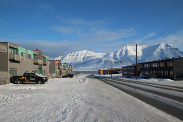 Longyearbyen town panorama in Svalbard, Norway. Remote arctic settlement with colorful houses, traditional wooden architecture, industrial heritage under winter snow and majestic polar mountains. © 國樹潘