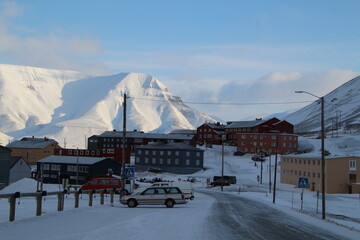 Longyearbyen town panorama in Svalbard, Norway. Remote arctic settlement with colorful houses, traditional wooden architecture, industrial heritage under winter snow and majestic polar mountains. © 國樹潘