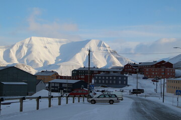 Longyearbyen town panorama in Svalbard, Norway. Remote arctic settlement with colorful houses, traditional wooden architecture, industrial heritage under winter snow and majestic polar mountains. © 國樹潘