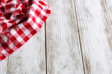 Obraz premium Red checkered cloth on white wooden table with rustic copy space