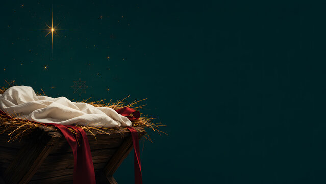 Wooden manger filled with hay and white swaddling cloth under a bright shining star in the night sky representing the biblical christmas nativity scene with copy space