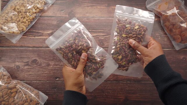 Sorting and packing different nuts and dried fruits at home