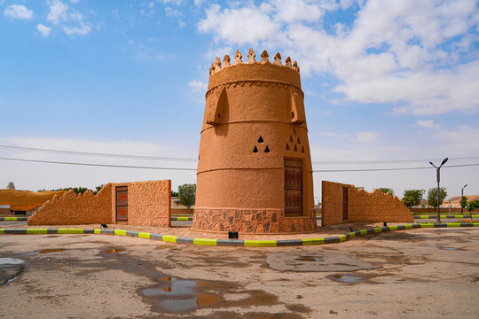 A traditional mud brick watchtower and defensive wall in the heritage village of Ushaiqer, Saudi Arabia