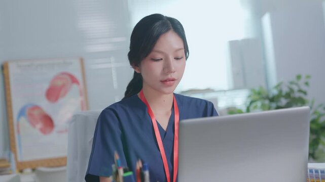 Doctor entering electronic medical records. Medical, asian woman working with computer in medical consultation at hospital. which are recording diagnoses and patient symptoms. Healthcare and medicine
