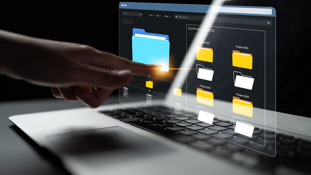 Hand Interacting with Digital Interface for File Management on Laptop Display with Abstract Technology and Data Visualization Elements. Bitwise.