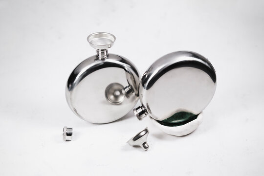 stainless steel or silver hip flask  funnel  close up isolated on white background