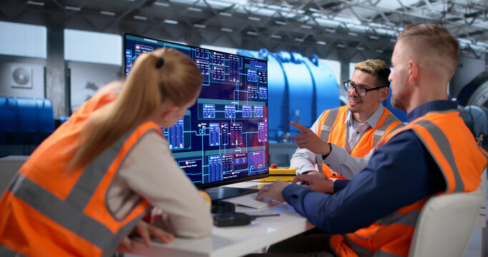 Workers In Power Plant Control Room Checking System Instruments