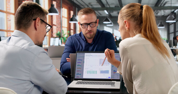 Compliance Manager Leads Diverse Team Reviewing Risk Data Dashboard