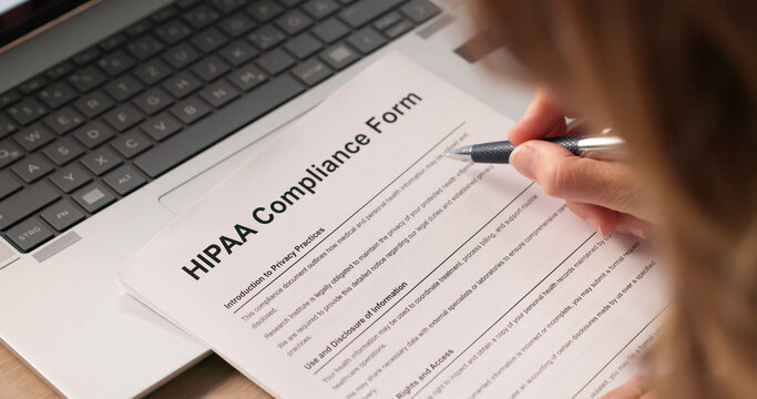 Woman Reviewing Medical Documents To Ensure Patient Privacy