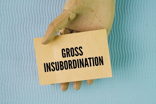 Paper with the word gross insubordination. severe and intentional act of workplace disobedience where an employee blatantly refuses to follow a lawful, reasonable order