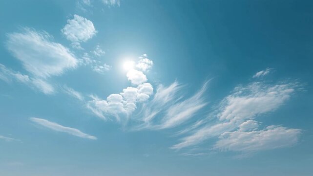 Bright sun shining in clear blue sky with soft wispy white cloud formations on a sunny day, natural weather atmosphere, outdoor daytime scene