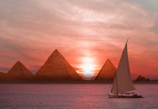 Beautiful Nile scenery with traditional Felluca sailing boat in the Nile on the way to Giza pyramids - Cairo, Egypt