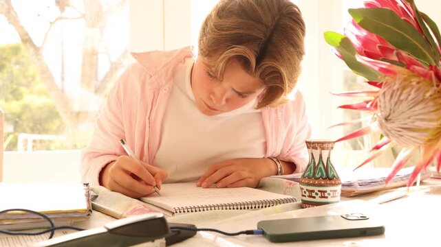 young boy doing homework at home