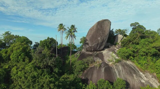 Aerial Orbit of Granite Boulder Revealing Jungle Sea and Islands at Koh Samui Thailand
