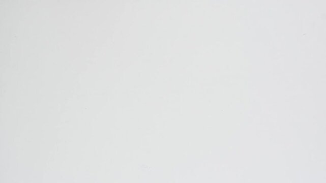 Amber supplement bottle rolls across white tabletop and exits frame, creating minimalist healthcare product motion scene