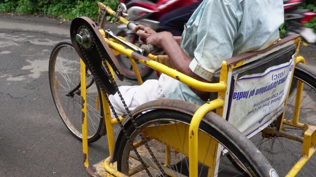 Disabled hand cranked tricycle in motion