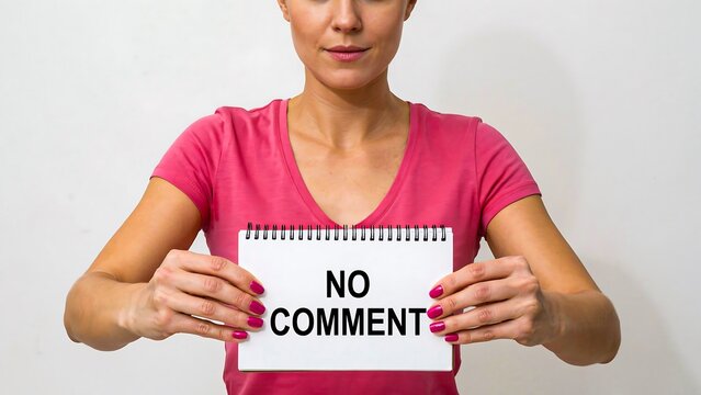 Person holding no comment sign representing silence privacy and neutral communication concept
