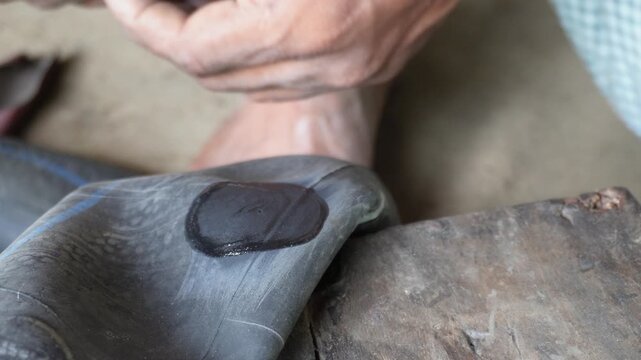 Repairing bicycle tube puncture with rubber patch