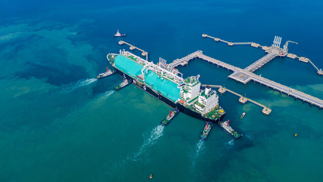 LNG Liquiefied Natural Gas tanker anchored in Gas terminal gas tanks for storage. Oil Crude Gas Tanker Ship. LPG at Tanker Bay Petroleum Chemical or Methane freighter export import