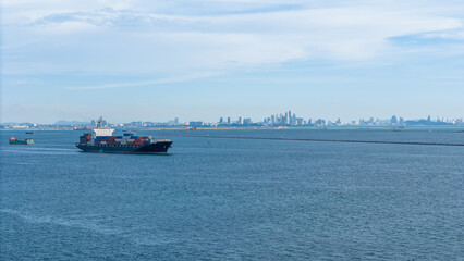 Fototapeta premium cargo container ship sailing on the deep blue ocean, representing global maritime logistics, international shipping, and commercial trade.