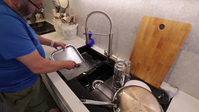 wash a serving tray in the kitchen